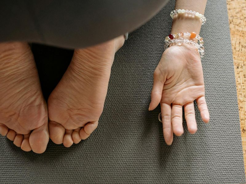 Detailed view of yoga mat and hands during practice